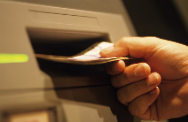 Canadian dollar withdrawal from ATM at night, close-up