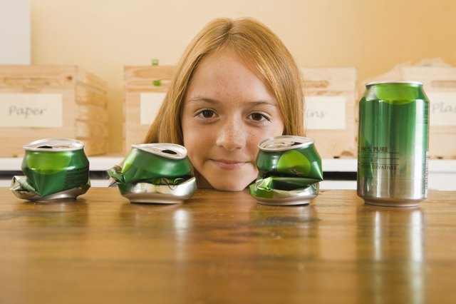 Girl with crushed aluminum cans