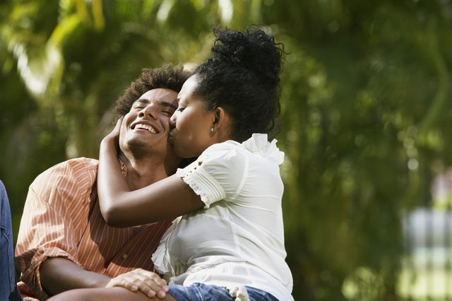 South American couple kissing in park