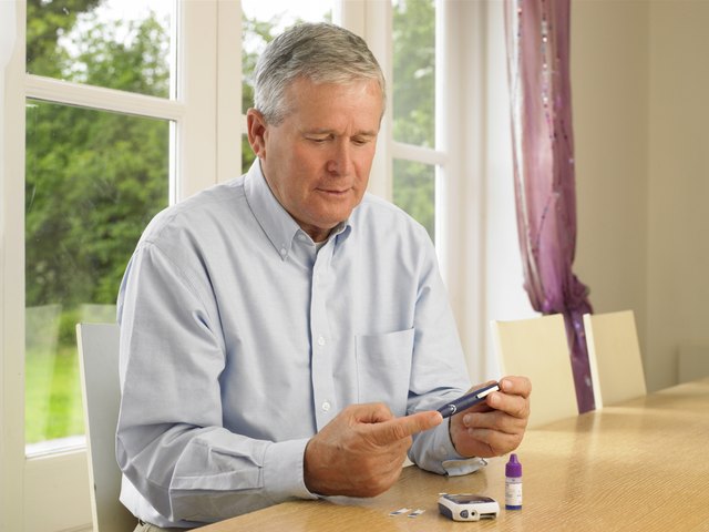 Man using glucometer for diabetes