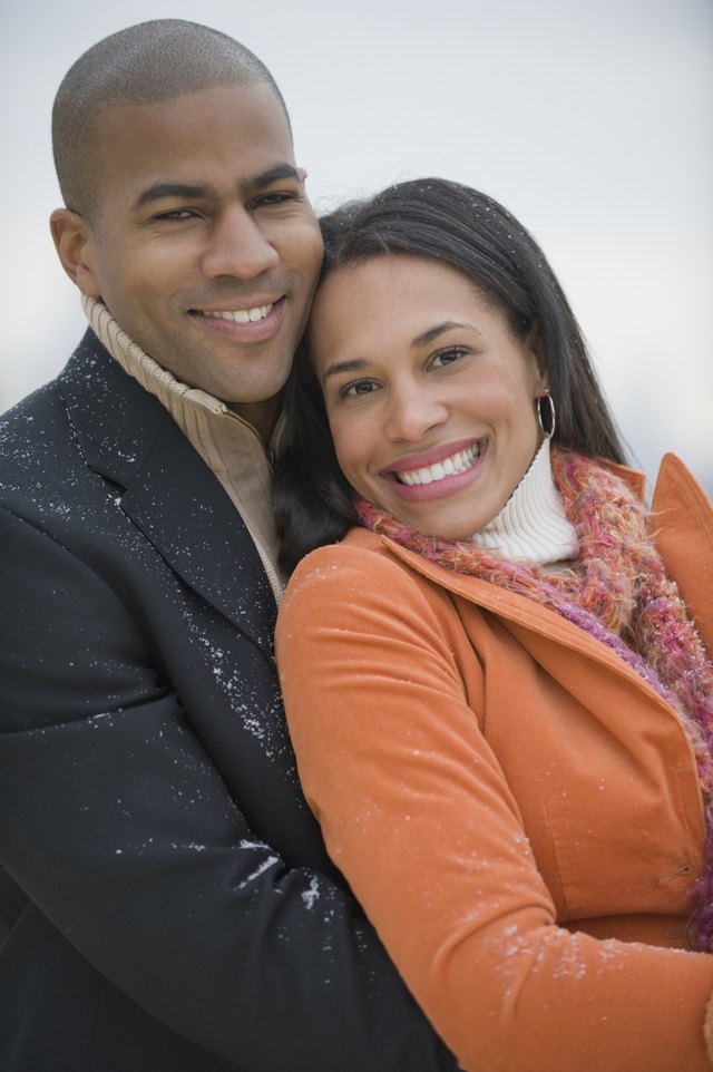 Couple hugging in snow