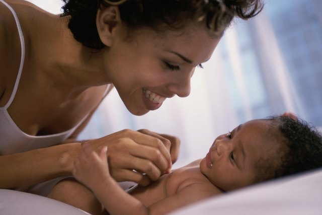 Close-up of a mother playing with her baby boy