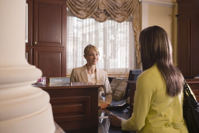 Woman at bank counter conversing with teller