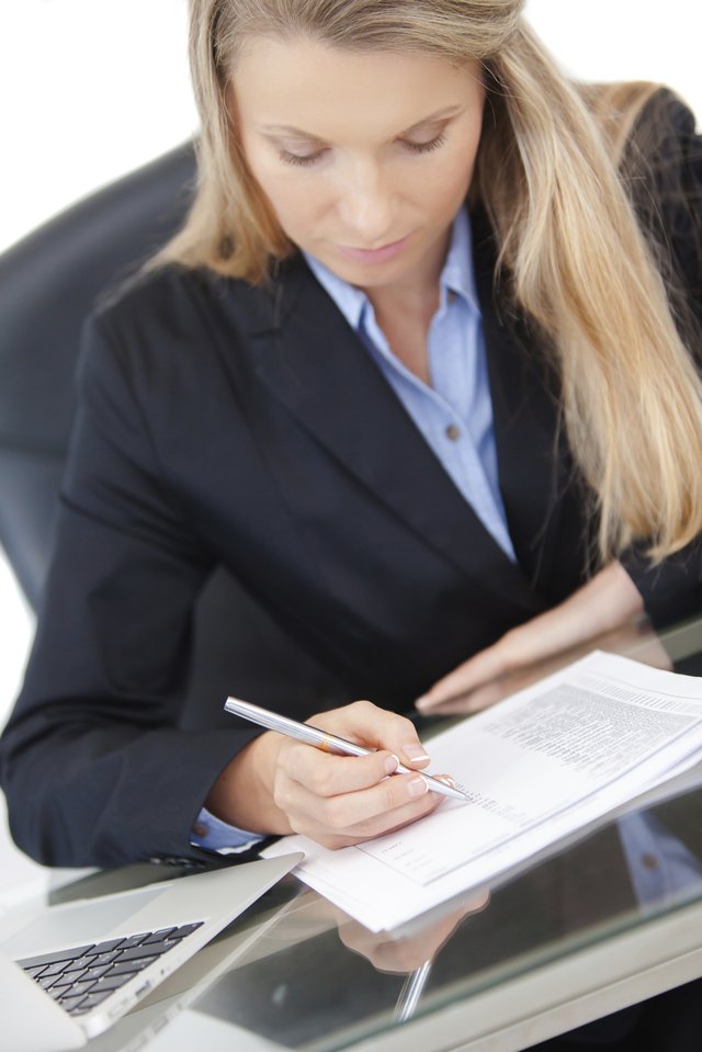 Close-up of working businesswoman at the desk
