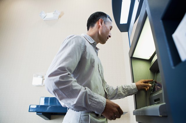 Man using cash machine
