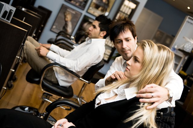 Hair stylist with client in beauty salon
