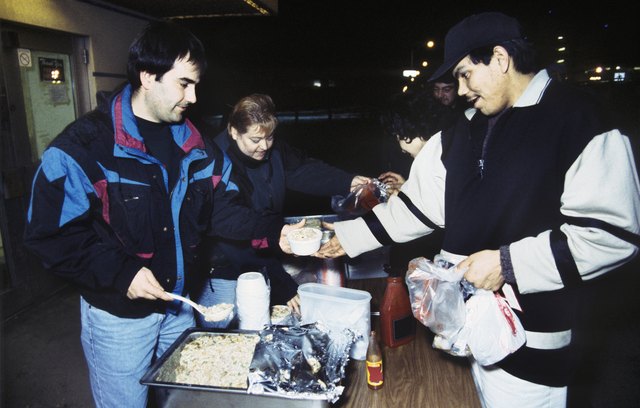 Volunteers and homeless at soup kitchen