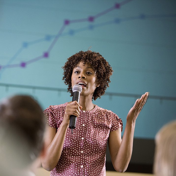 Woman asking a question at an informational meeting